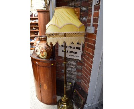 A brass adjustable standard lamp, on circular base. 