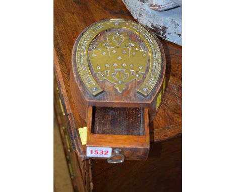 An antique oak and brass mounted novelty 'horse shoe' cribbage board.
