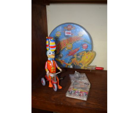 A Made in Western Germany clockwork tinplate duck on tricycle, 21.5cm high; together with a vintage 'Fireball' bagatelle; and