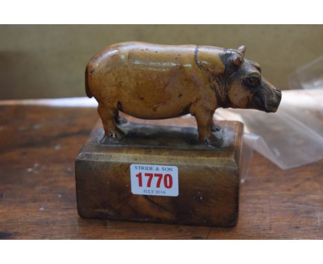 A carved wood model of a hippopotamus, 13cm wide. 