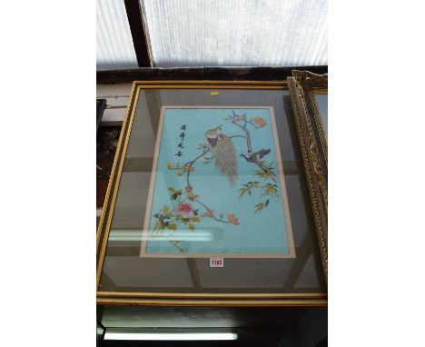 An oriental silk embroidered panel of a peacock, 49.5 x 34cm; and another oriental embroidered silk panel of a bird in a flow