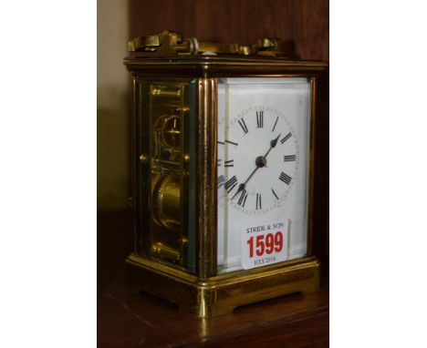 An old brass carriage clock, striking on a gong, height including handle 16cm, with winding key.  Condition Report: Clock app