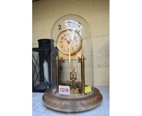 A brass anniversary clock, on marble base, with glass dome, 28cm high, with key.