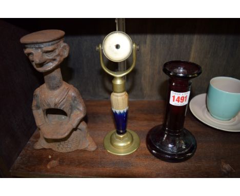 A cast iron 'Tough Nut' figural nut cracker, 19.5cm high; together with a Doulton stoneware and brass watch stand; and a Vict