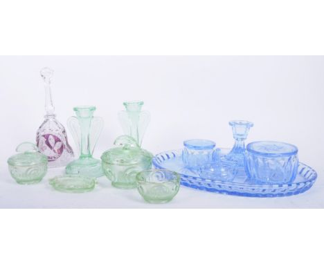 A retro mid 20th century Art Deco style cut glass dressing set, comprising lidded pots, a bell and candlestick holders in lig