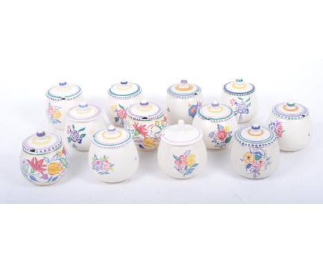 A collection of twelve retro mid century lidded sugar pots by Poole Pottery, each with cream ground and floral decoration, wi