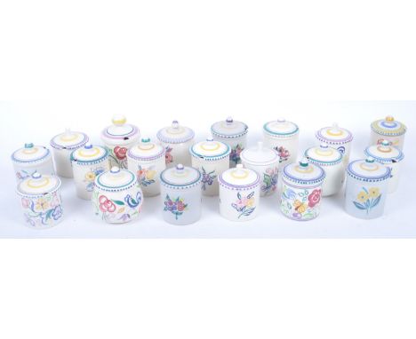 A collection of twenty retro mid 20th century lidded sugar pots by Poole Pottery, each with cream ground and floral decoratio