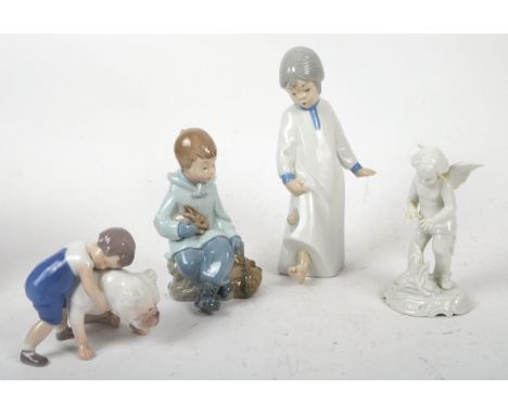 A collection of four 20th century continental decorative figures, comprising a Dresden white cherub figure warming its hands,