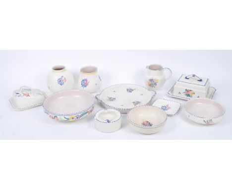 A collection of twenty retro early - mid 20th century ceramics by Poole Pottery each with cream ground and floral decoration,