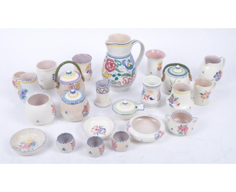 A collection of retro mid 20th century ceramics by Poole Pottery each with cream ground and floral decoration, with colourful