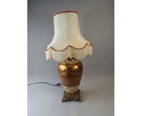 A Ceramic Table Lamp on Ormolu Stand with Four Scrolled Feet.