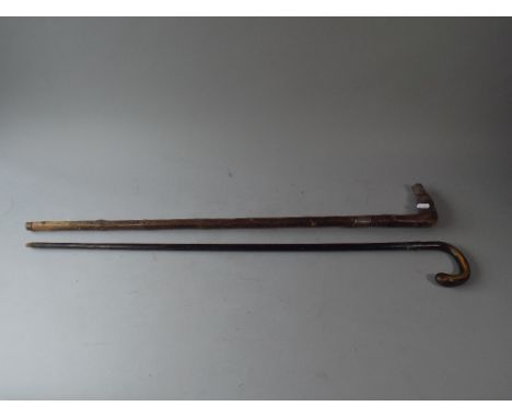 A Horn Handled Ebonised Walking Cane and A Silver Mounted Thorn Stick.