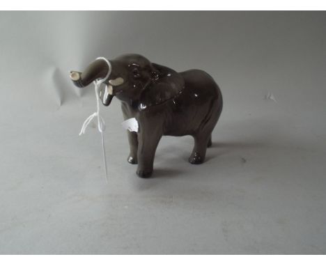 A Beswick Elephant with Tusk in Salute.