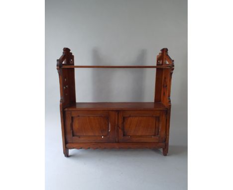 An Edwardian Mahogany Wall Shelf with Cupboard Base and Pierced Supports.