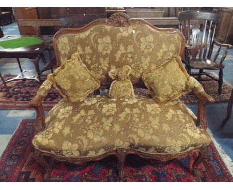 A French Walnut Framed Two Seater Salon Settee with Serpentine Front, Cabriole Legs and Carved Top Rail.