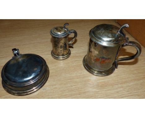 A Dunhill lighter in form of a tankard of ale; a silver plated Dunhill ashtray; a cigarette holder in the form of a tankard a