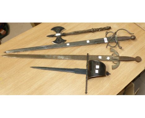 Three reproduction mediaeval style swords; a reproduction battle axe