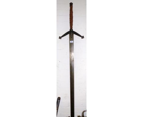 A medieval style 2 handed sword; a modern sabre in brass and velvet scabbard