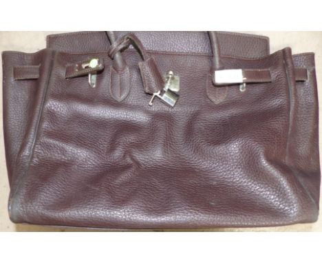 A brown leather handbag with padlock closure