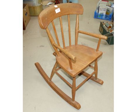 A child's stick back rocking armchair