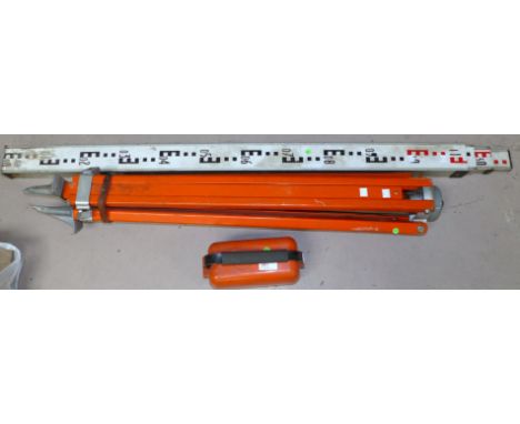 A modern surveyor's level and tripod and 4 metre 4 section telescopic levelling staff