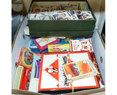 A collection of cigarette and trade cards; packs of playing cards and games