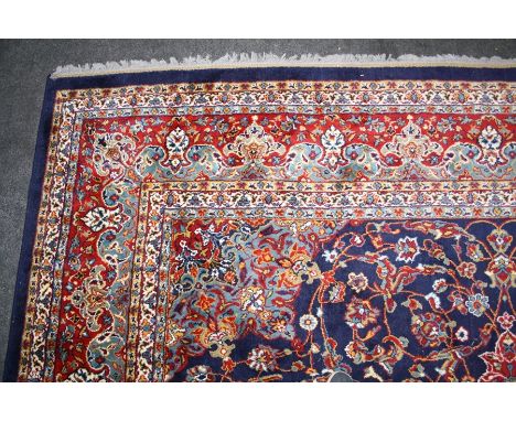 A royal blue ground carpet in the style of "Adebil carpet"with central lozzenge and multiple borders.300 x 400cmCONDITION:Goo