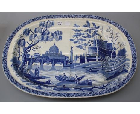 An early 19th century, probably Spode "Tiber" pattern, blue and white transfer printed pottery "tree and well" meat plate.53c