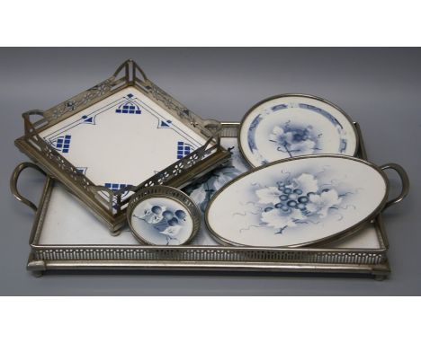 A 20th century Continental white metal gallery tray with cherry decorated ceramic insert together with other similar wares.