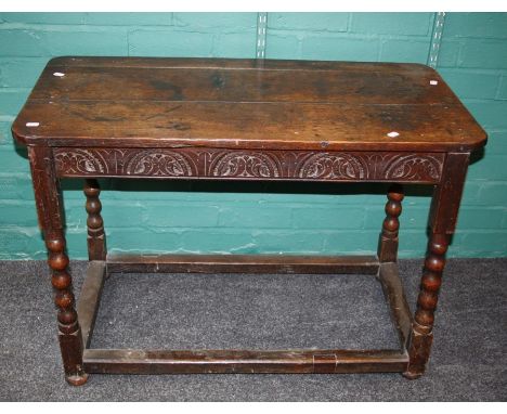 An 18th century and later oak side table, the rectangular planked top over demi-lunette carved frieze on bobbin turned suppor
