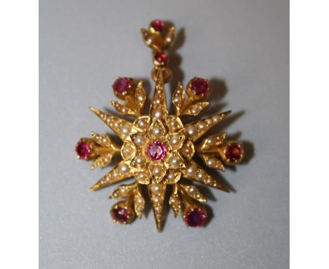 A late Victorian ruby and seed pearl brooch cum pendant, the six point star set with circular cut rubies and split seed pearl