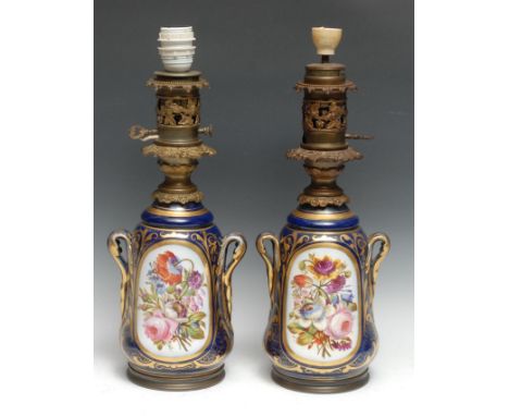 A pair of Continental porcelain table lamps, painted with colourful summer flowers, picked out in gilt with scrolling foliage