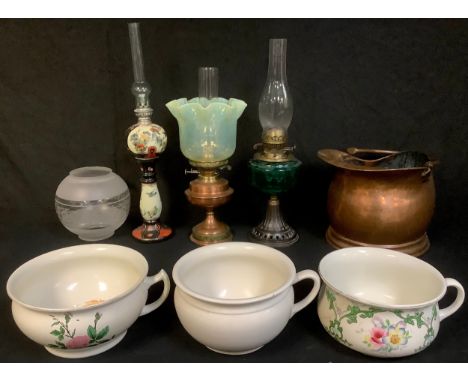 A late 19th century oil lamp, green glass font, cast iron base, frosted glass shade; another, 20th century copper and brass o