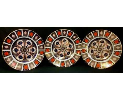 A Royal Crown Derby Imari 1128 pattern dinner plate, 27cm, printed marks, second quality; two others, seconds (3) 