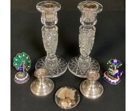 A pair of George V silver boudoir candlesticks, Birmingham 1929; an Indian silver and enamel model pof a peacock; another, of