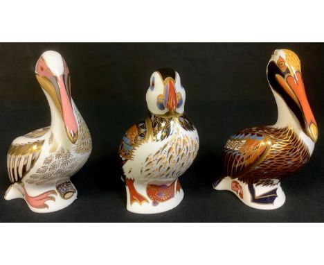 A Royal Crown Derby paperweight, White Pelican, silver stopper, second, printed mark; others, Brown Pelican, silver stopper, 