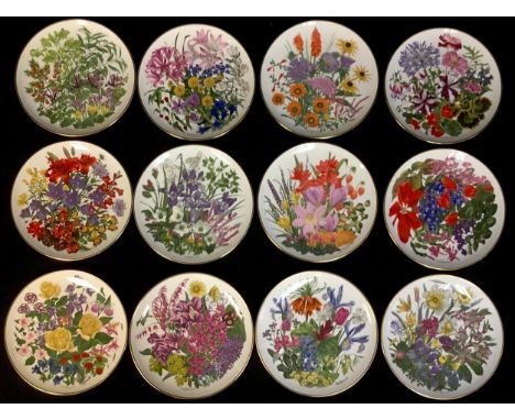 A Franklin Porcelain set of twelve plates, The Royal Horticultural Society Flowers of the Year Plate Collection, January-Dece