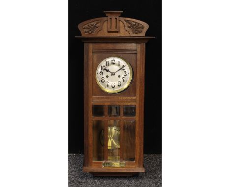An early 20th century oak wall clock, rectangular brass plaque inscribed Presented to E.E.Ratcliff Esq. By the Employees of t