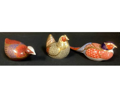 A Royal Crown Derby paperweight, Farmyard Hen, silver stopper, second; others, Pheasant, no stopper; another game bird, silve