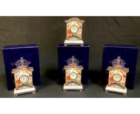 A Royal Crown Derby Haiku pattern miniature mantel clock, 7.5cm, second quality, boxed; three others, two boxed (4) 