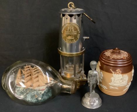 An Eccles miner's lamp, The Protector; a ship in a bottle; a Royal Doulton salt glazed tobacco jar and cover; a pewter Grenad