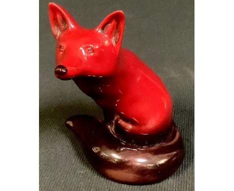 A Royal Doulton Flambe model of a seated fox, tail curled about him, 10cm, printed mark 