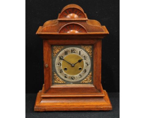 A late 19th century oak bracket clock, 16cm silvered dial inscribed with Arabic numerals, twin winding holes, 8 day movement 