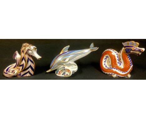 A Royal Crown Derby paperweight, Dolphin, silver stopper, second, printed mark; others, Seahorse, no stopper, second; Dragon,