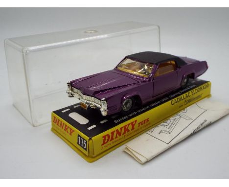 Dinky Toys  - A boxed Dinky Toys #175 Cadillac Eldorado. The model in metallic purple with black roof and orange plastic inte