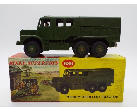 Dinky Toys - A boxed Dinky Toys #689 Medium Artillery tractor. The model in green with driver and no glazing, appears to be i