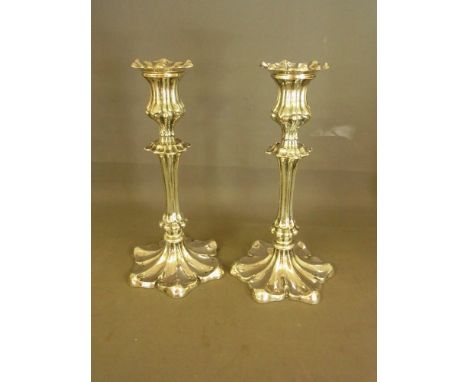 A good pair of  silver candlesticks with fluted baluster stems and petal shaped base - hallmarked Birmingham 1912 - 13 maker 