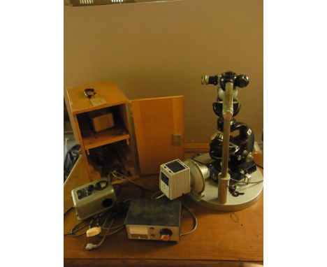 A Carl Zeiss 4298301 black enamel binocular microscope with five objectives, transformers and light box and carry case