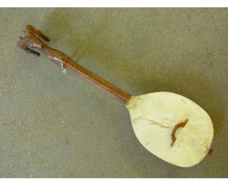 A carved hardwood one string instrument - possibly a Bosnian Gusle with Rams head head piece - Length 60 cm 
Condition report