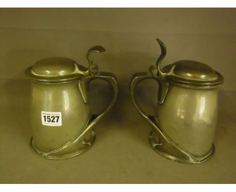 A pair of pewter Tudric Archibold Knox lidded tankards - Height 18cm
Condition report:  Both overall sound but various dents 